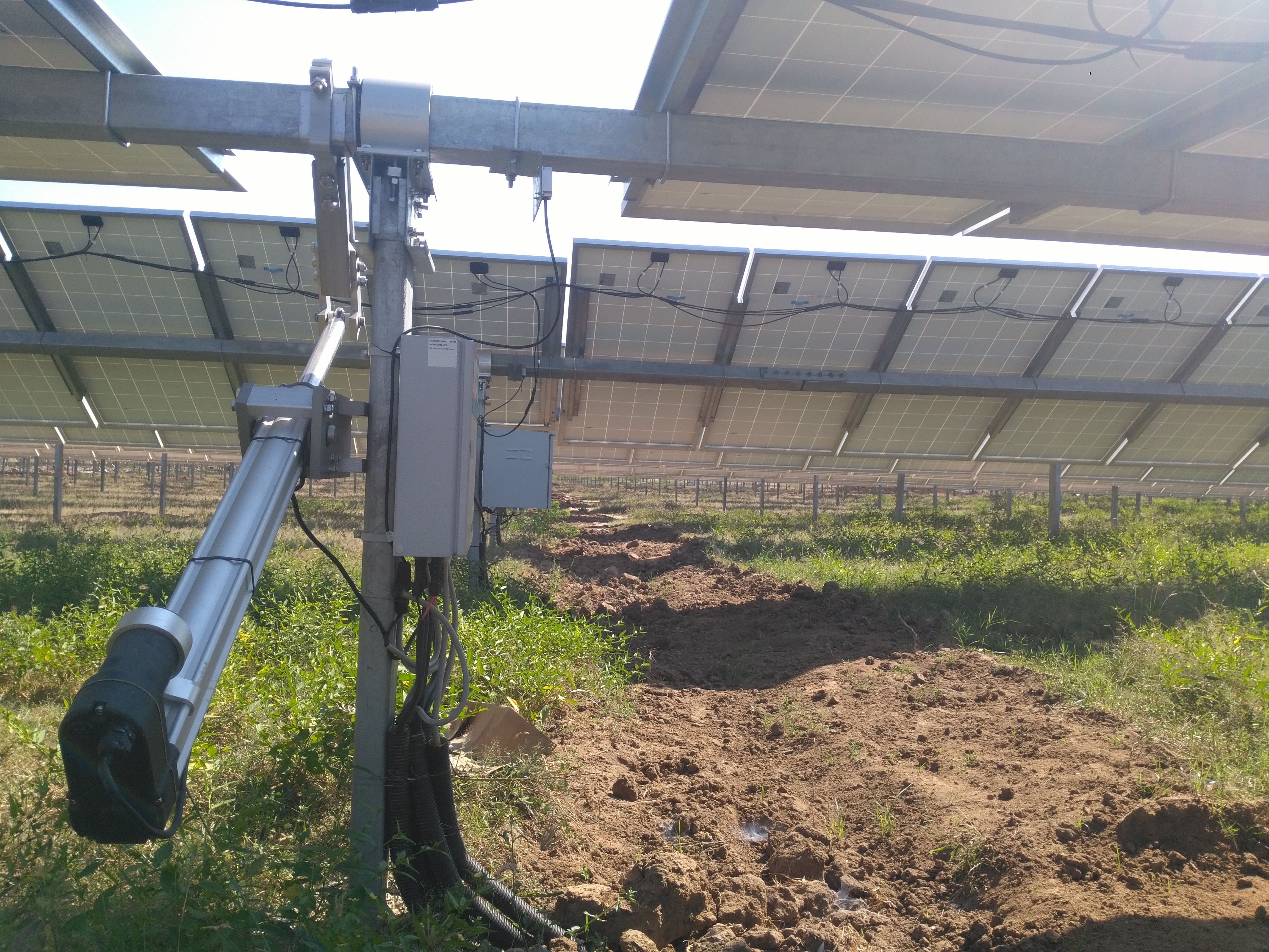 Close up of a heavy-duty linear actuator adjusting the angle of a solar panel tracker